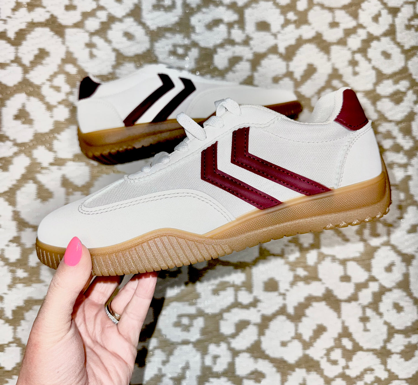 Maroon and white sneakers